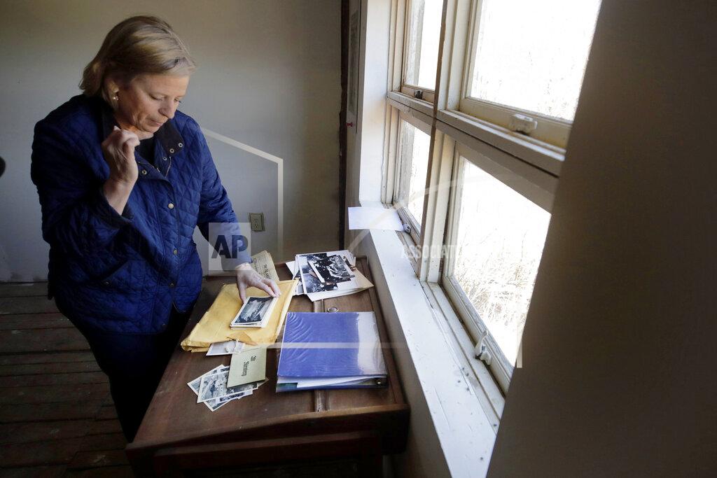 Charles Krupa Emily DiPalma Aho looks over photographs and memorabilia of her father, Emilio DiPalma, a World War II veteran, at her home in Jaffrey, N.H., Wednesday, May 13, 2020. Emilio DiPalma, who as a 19-year-old U.S. Army infantryman stood guard at the Nuremberg Nazi war crimes trials, died last month at the age of 93 after contracting the coronavirus at Holyoke Soldiers' Home in Massachusetts. (AP Photo/Charles Krupa)