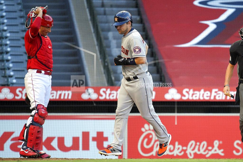 Mark J. Terrill Houston Astros' Josh Reddick, right, scores as Los Angeles Angels catcher Jason Castro watches after George Springer was walked with the bases loaded during the second inning of a baseball game Friday, July 31, 2020, in Anaheim, Calif. (AP Photo/Mark J. Terrill)