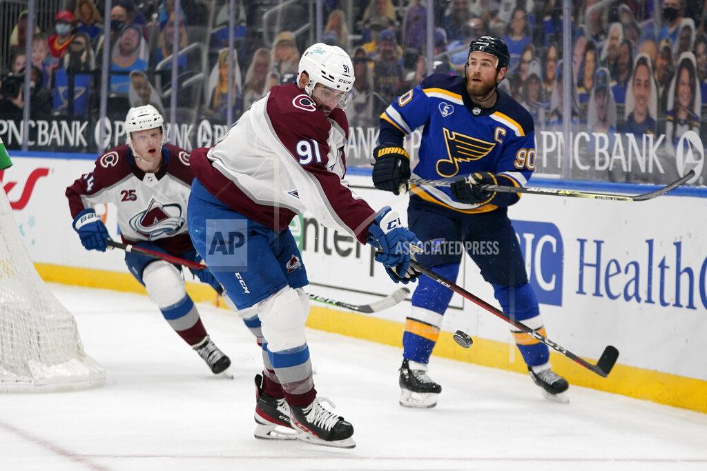 Jeff Roberson Colorado Avalanche's Nazem Kadri (91) reaches for a loose puck along side teammate Carl Soderberg and St. Louis Blues' Ryan O'Reilly (90) during the third period of an NHL hockey game Thursday, April 22, 2021, in St. Louis. (AP Photo/Jeff Roberson)