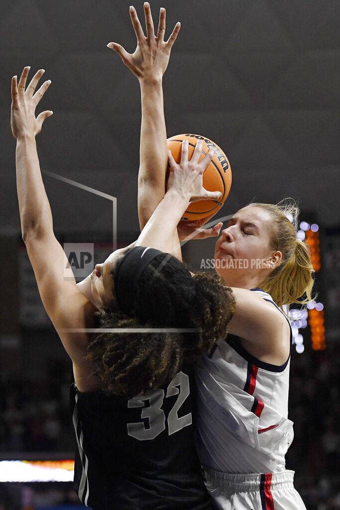 Jessica Hill Central Florida's Brittney Smith, left, guards Connecticut's Dorka Juhász during the second half of a second-round college basketball game in the NCAA tournament, Monday, March 21, 2022, in Storrs, Conn. (AP Photo/Jessica Hill)