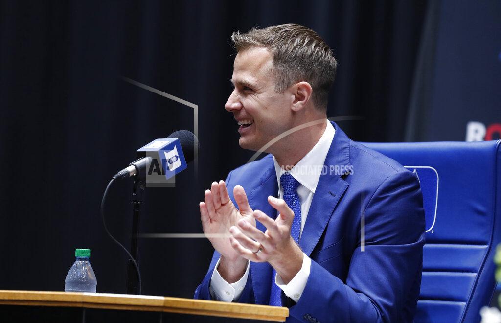 Ethan Hyman Jon Scheyer applauds people in the crowd after being introduced during an NCAA college basketball press conference at Cameron Indoor Stadium in Durham, N.C., Friday, June 4, 2021. Scheyer will spend the upcoming year in his role as associate head coach as coach Mike Krzyzewski chases one more championship in a Hall of Fame career. Then it’s up to the 33-year-old Scheyer to take over ahead of the 2022-23 season in the program’s first coaching change in more than four decades. (Ethan Hyman/The News & Observer via AP)