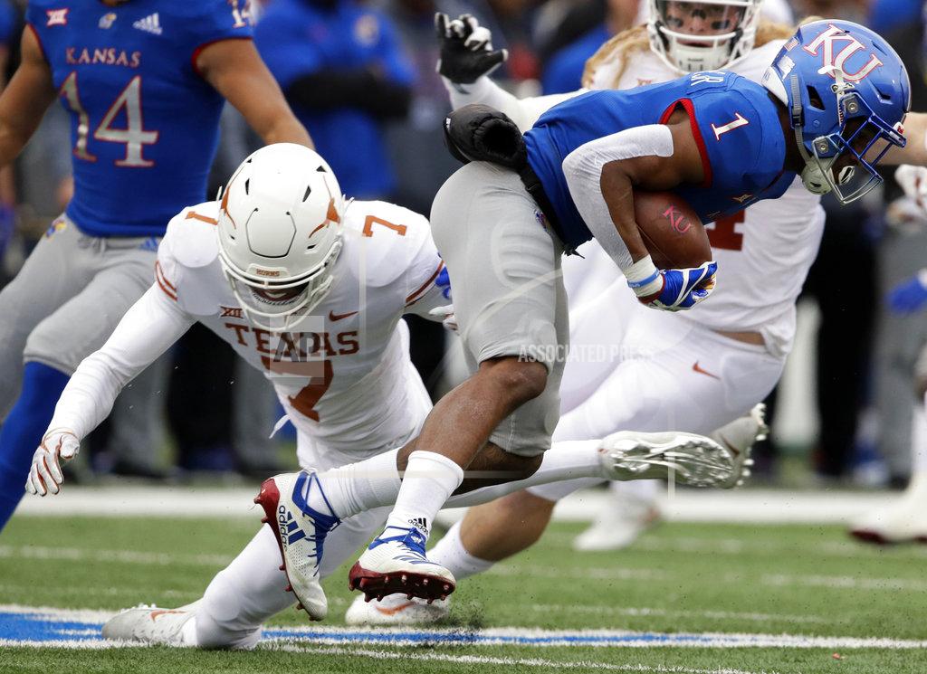 Orlin Wagner Kansas running back Pooka Williams Jr. (1) breaks a tackle by Texas defensive back Caden Sterns (7) during the first half of an NCAA college football game in Lawrence, Kan., Friday, Nov. 23, 2018. (AP Photo/Orlin Wagner)