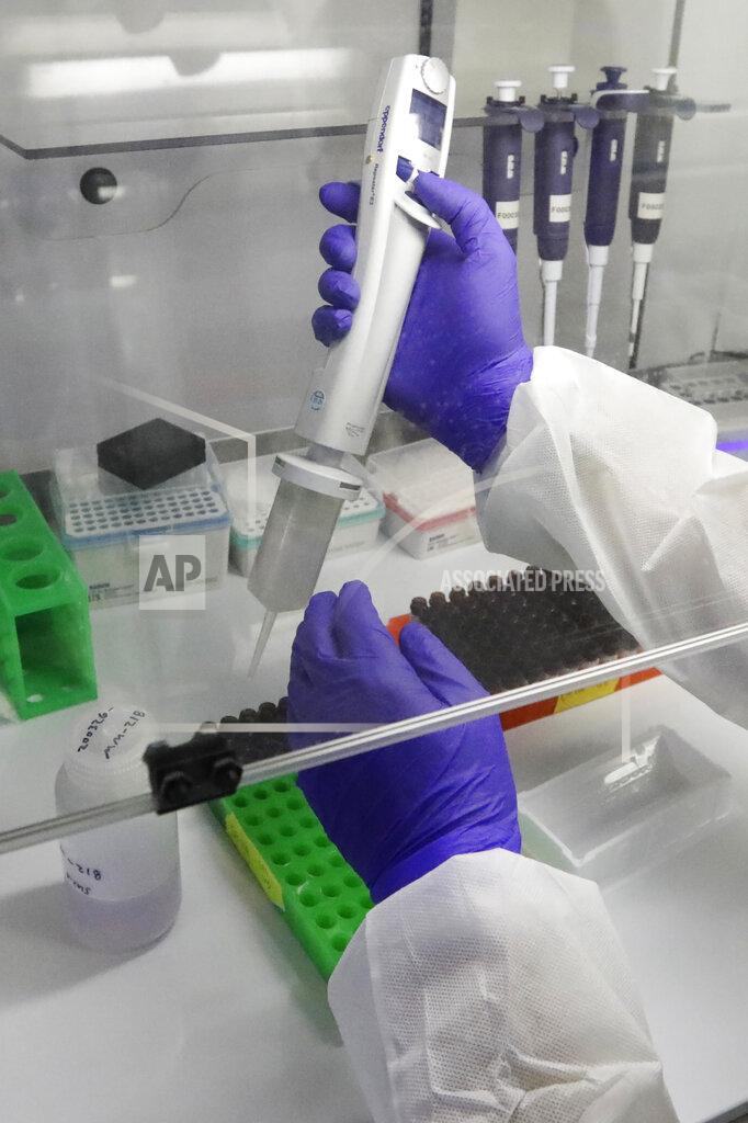 A Co-Diagnostics lab technician manufactures COVID-19 testing kits Friday, March 27, 2020, in Salt Lake City. The company says it has the capacity to produce 50,000 test kits daily from its Salt Lake City facility. (AP Photo/Rick Bowmer)