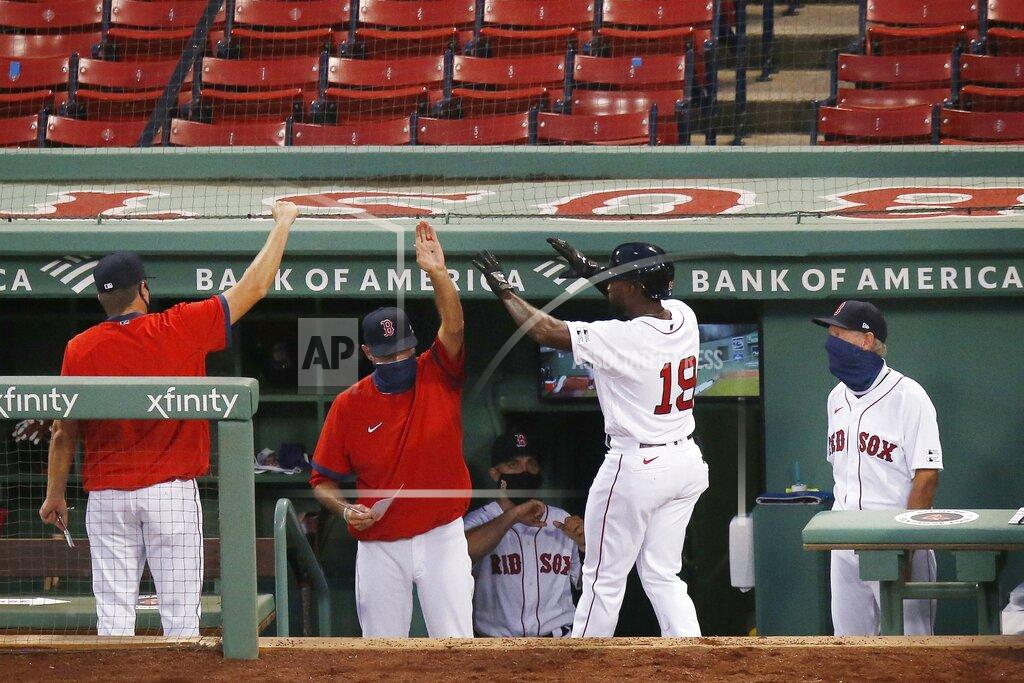 Michael Dwyer Boston Red Sox's Jackie Bradley Jr. (19) celebrates after scoring on a double by J.D. Martinez during the third inning of an opening day baseball game against the Baltimore Orioles at Fenway Park, Friday, July 24, 2020, in Boston. (AP Photo/Michael Dwyer)