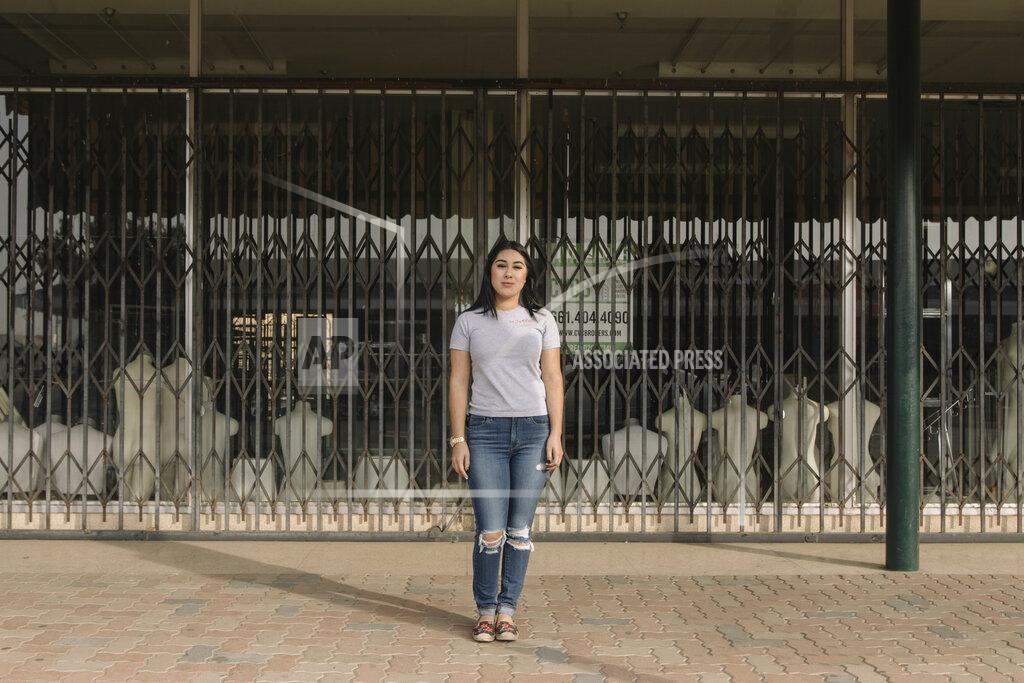 Madeline Tolle Alexandra Orozco stands for a portrait outside of the closed J.C. Penney where she was laid off from, in Delano, Calif., on Sunday, Dec. 6, 2020. “Not a lot of people worked there but the store really meant something to Delano,” she explains. “People are really sad. It’s the only place that sold nice, branded clothes, like Levi’s. And it’s been here for a very long time. My mom used to go shopping with her mom there but she can’t relive that memory because the store is gone.” (Madeline Tolle/The Fuller Project via AP)