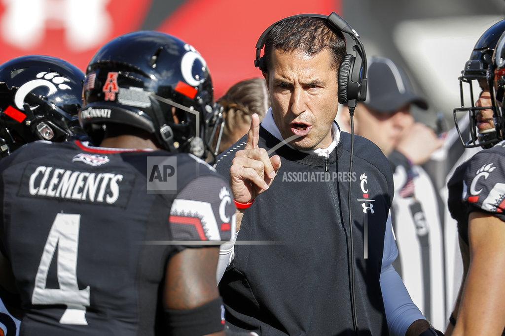 John Minchillo FILE - In this Saturday, Nov. 3, 2018, file photo, Cincinnati head coach Luke Fickell, right, speaks with linebacker Malik Clements (4) before an NCAA college football game against Navy in Cincinnati. No. 19 Cincinnati is in contention for the American Athletic title at it prepares to play at 11th-ranked and undefeated UCF on Saturday.(AP Photo/John Minchillo, File)