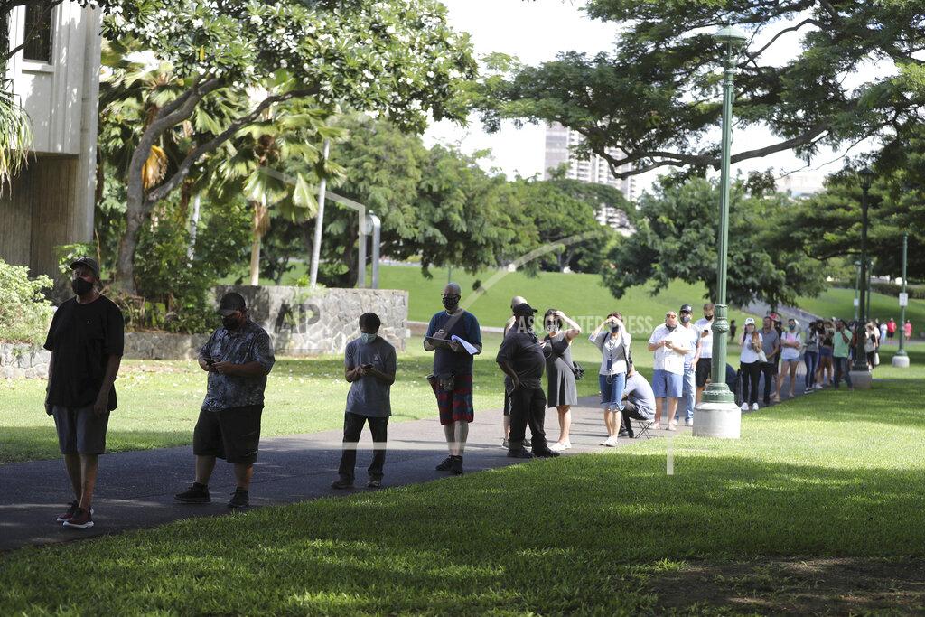 Marco Garcia A long line of people waiting to vote stretches around City Hall on Election Day, Tuesday, Nov. 3, 2020, in Honolulu. (AP Photo/Marco Garcia)