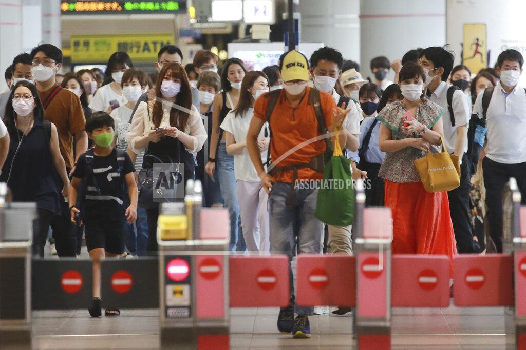 Koji Sasahara People wearing face masks to protect against the spread of the coronavirus walk at a train station in Tokyo, Wednesday, July 28, 2021. Tokyo Gov. Yuriko Koike on Wednesday urged younger people to cooperate with measures to bring down the high number of infections and get vaccinated, saying their activities are key to slowing the surge during the Olympics. (AP Photo/Koji Sasahara)