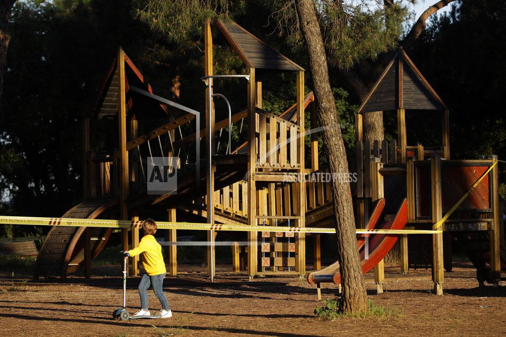 Alessandra Tarantino FILE - In this May 4, 2020 file photo, a child looks at a sealed-off playground at Rome's Villa Pamphili park as the park reopened after several weeks of closure, part of nationwide limited easing of some coronavirus lockdown restrictions, in Rome. A national survey of the psychological impact of coronavirus lockdowns on Italian children presented in Rome on Tuesday, June 16, 2020, has quantified what many parents noticed offhand during weeks cooped up at home: Their kids were more irritable, had trouble sleeping and for some of the youngest, wept inconsolably and regressed developmentally. (AP Photo/Alessandra Tarantino)