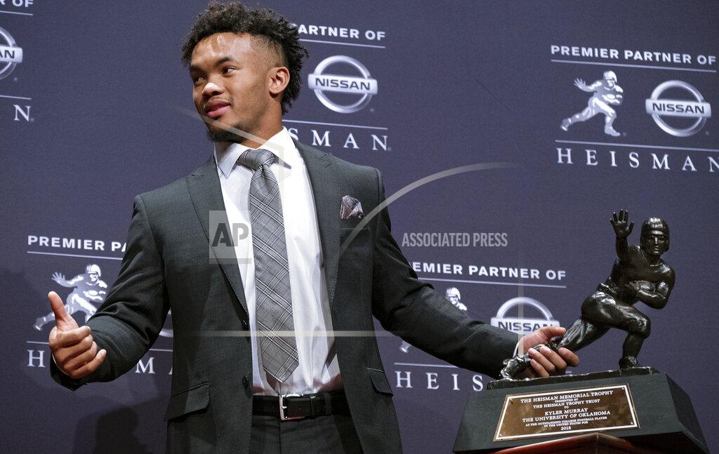 Craig Ruttle FILE - In this Dec. 8, 2018, file photo, Oklahoma quarterback Kyler Murray holds the Hesiman Trophy after winning the award in New York. Murray's locker remained empty on Monday, Feb. 11, 2019, in the spring training clubhouse of the Oakland Athletics, who say they are uncertain when or if the Heisman Trophy winner will report to the baseball team he signed with last summer. Billy Beane, Oakland’s executive vice president of baseball operation, said talks are continuing with Murray, who may drop baseball to pursue an NFL career. (AP Photo/Craig Ruttle, File)