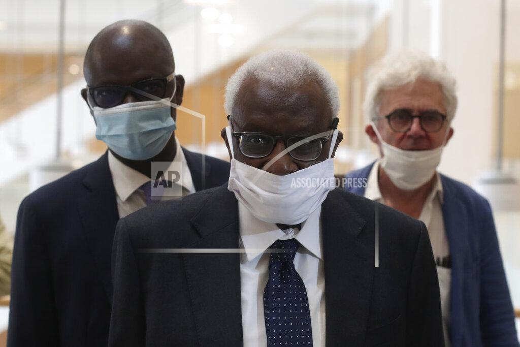 Thibault Camus Former president of the IAAF (International Association of Athletics Federations) Lamine Diack arrives with his lawyer William Bourdon, right, at the Paris courthouse, Monday, June 8, 2020. A sweeping sports corruption trial opened Monday in Paris involving allegations of a massive doping cover-up that reached to the top of world track and field's governing body. Lamine Diack, 87, who served as president of the body for nearly 16 years, is among those accused of receiving money from Russian athletes to hide their suspected doping so they could compete at the Olympics in 2012 and other competitions. His son Papa Massata Diack is also charged in the case. (AP Photo/Thibault Camus)