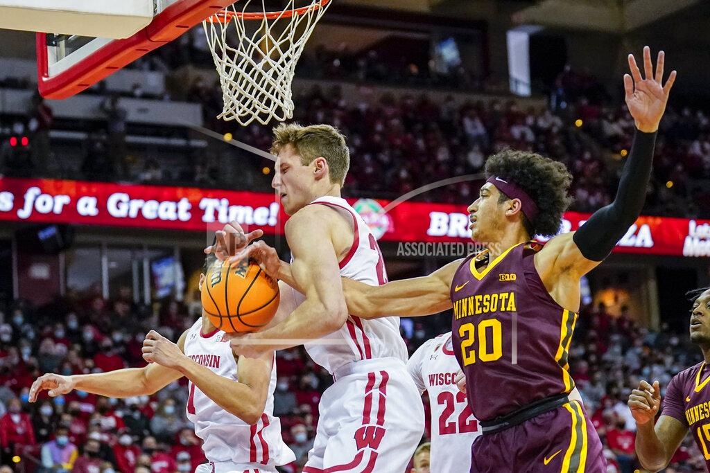 Andy Manis Wisconsin's Ben Carlson grabs a defensive rebound against Minnesota's Eylijah Stephens (20) during the first half of an NCAA college basketball game Sunday, Jan. 30, 2022, in Madison, Wis. (AP Photo/Andy Manis)