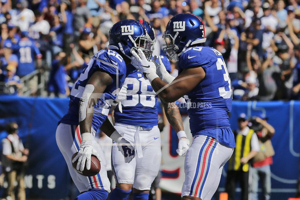 Adam Hunger New York Giants' Wayne Gallman, left, celebrates his touchdown with Eli Penny during the first half of an NFL football game against the Washington Redskins, Sunday, Sept. 29, 2019, in East Rutherford, N.J. (AP Photo/Adam Hunger)