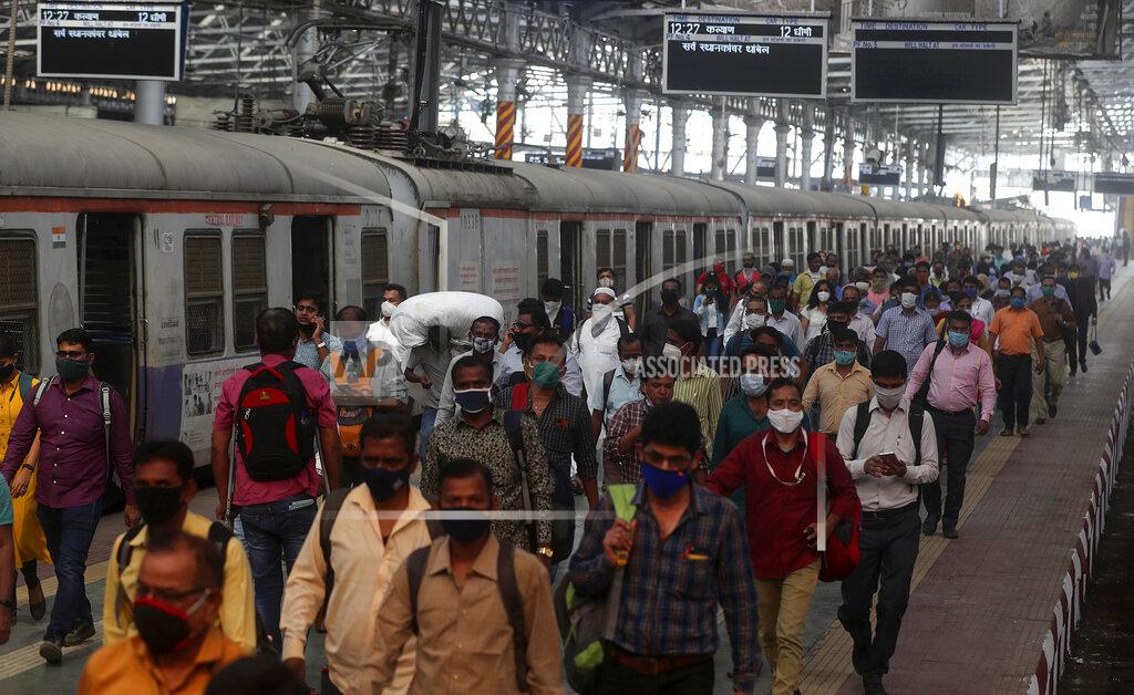 Indian commuters crowd the Chhatrapati Shivaji train Terminus in Mumbai, India, Monday, Feb 1, 2021. India’s government on Monday announced it will boost healthcare spend amid the coronavirus pandemic and said it was committed to the development of the financial institutions and shoring up of infrastructure to get the pandemic-ravaged nation back as the world's fastest-growing major economy.(AP Photo/Rafiq Maqbool)