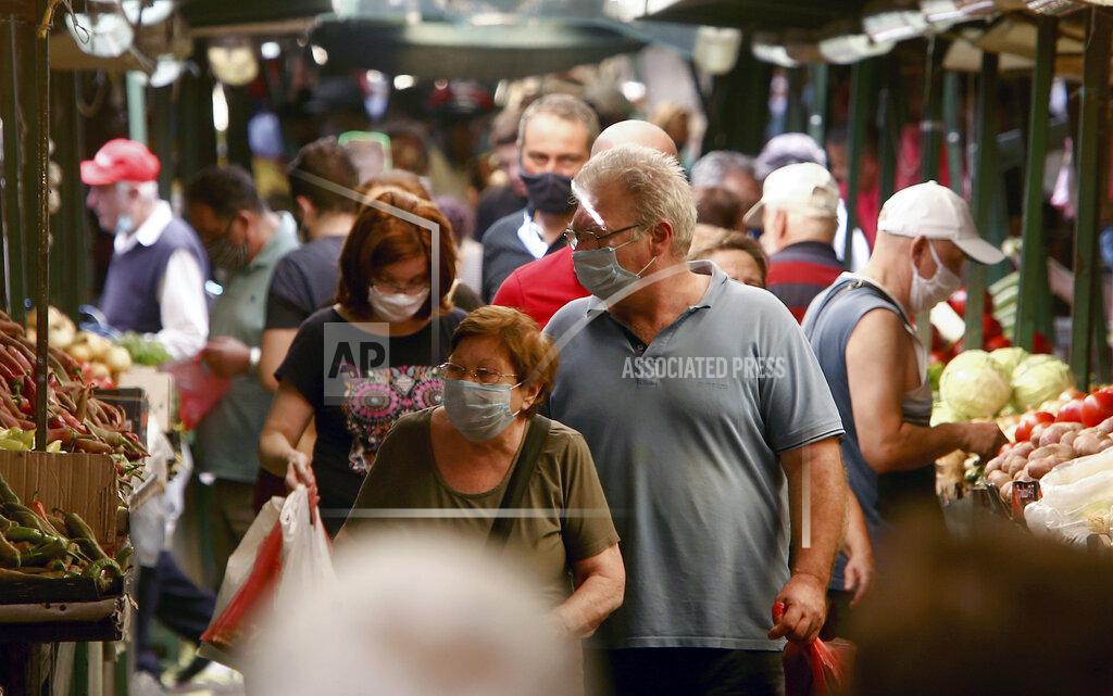Boris Grdanoski People wearing face masks shop at a green market in Skopje, North Macedonia, Sunday, Aug. 30, 2020. North Macedonia's parliament continues Sunday the debate on a vote of confidence for a new left-wing coalition government after the Social Democrats and their ethnic Albanian partners secured a majority of seats in July's general election. (AP Photo/Boris Grdanoski)