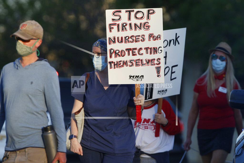 Jim Mone Nurses march to the Minnesota State Capitol after picketing at United Hospital Wednesday, May 20, 2020 in St. Paul, Minn. as they seek a say in worker protections, increased personal protection resources with higher safety standards, and an end to retaliation against workers who have tried to protect themselves from the COVID-19 virus. (AP Photo/Jim Mone)