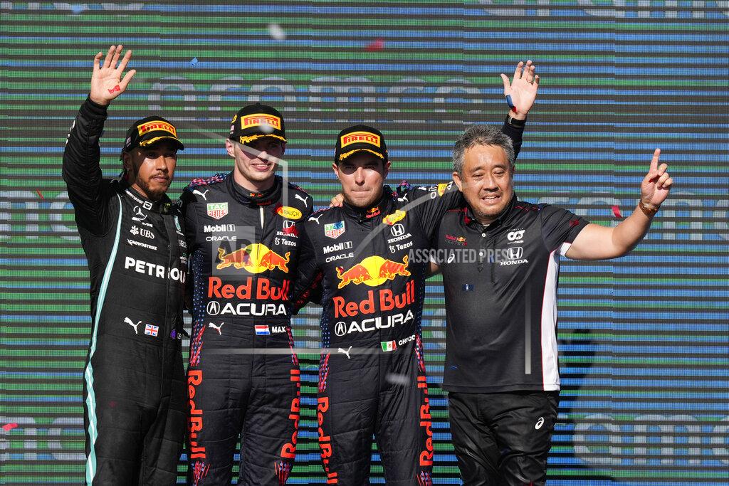 Nick Didlick From left to right, Mercedes driver Lewis Hamilton, of Britain, Red Bull driver Max Verstappen, of the Netherlands, Red Bull driver Sergio Perez, of Mexico, and Honda's F1 managing director Masashi Yamamoto celebrate after the Formula One U.S. Grand Prix auto race at Circuit of the Americas, Sunday, Oct. 24, 2021, in Austin, Texas. (AP Photo/Nick Didlick)