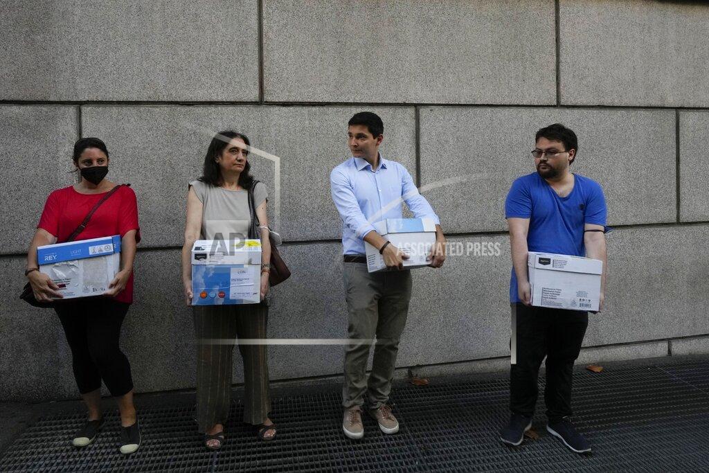 Antonio Calanni Members of an Italian association for consumer protection, hold boxes containing documents as they wait outside the Genoa's Palace of Justice during the opening of the first hearing of the trial for the Morandi bridge collapse, Thursday, July 7, 2022. Forty-three people were killed when a large stretch of the Morandi Bridge broke off August 14, 2018, on the eve of one of Italy's biggest vacation holidays. (AP Photo/Antonio Calanni)