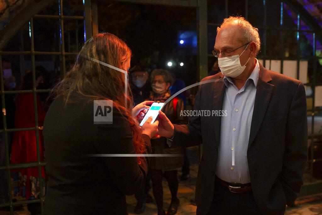 Maya Alleruzzo FILE - In this Tuesday, Feb. 23, 2021, file photo, a man presents his "green passport," proof that he is vaccinated against the coronavirus, on opening night at the Khan Theater for a performance where all guests were required to show proof of vaccination or full recovery from the virus, in Jerusalem. Vaccine passports are being developed in the U.S. to verify COVID-19 immunization status and allow inoculated people to more freely travel, shop and dine. (AP Photo/Maya Alleruzzo, File)