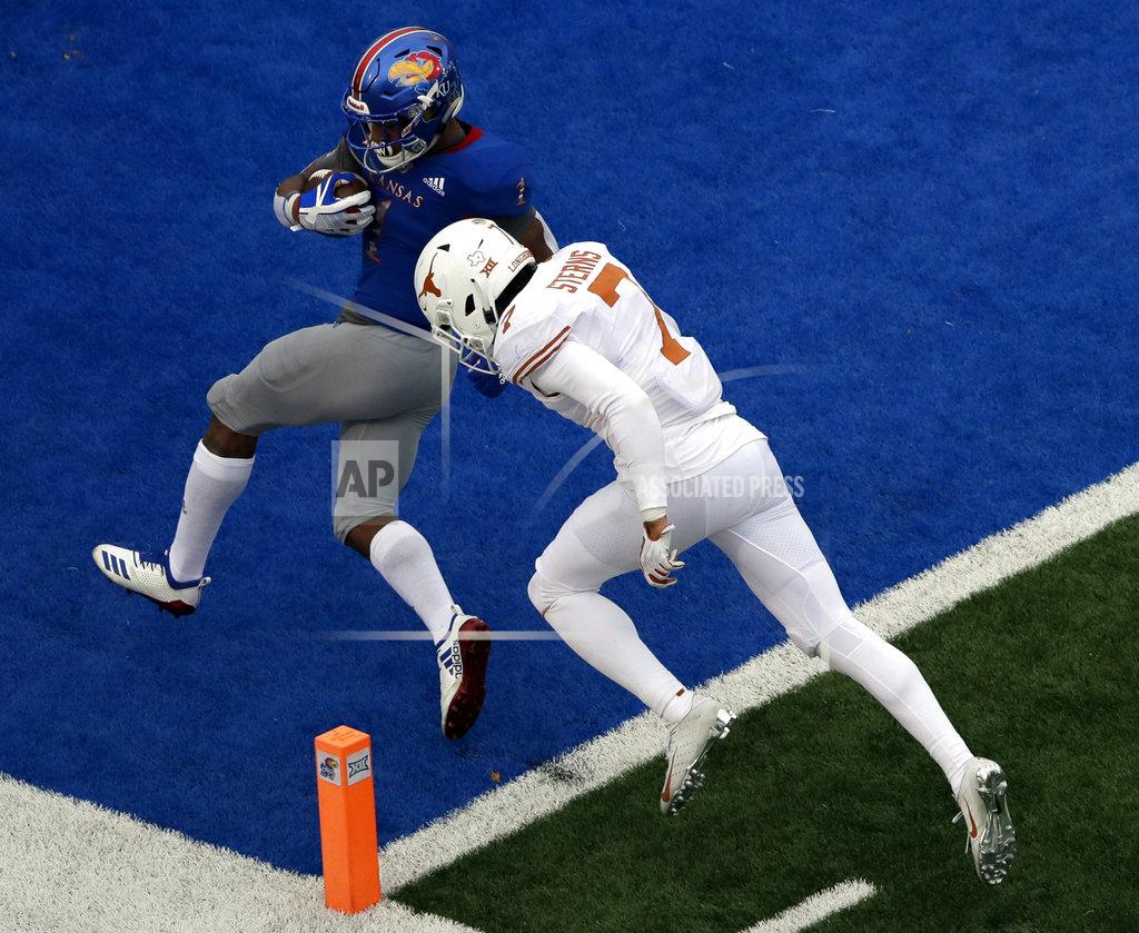 Orlin Wagner Kansas running back Pooka Williams Jr. (1) scores a touchdown while covered by Texas defensive back Caden Sterns (7) during the second half of an NCAA college football game in Lawrence, Kan., Friday, Nov. 23, 2018. (AP Photo/Orlin Wagner)