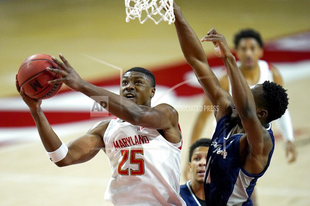 Julio Cortez Maryland forward Jairus Hamilton (25) goes up for a shot against St. Peter's forward KC Ndefo during the first half of an NCAA college basketball game, Friday, Dec. 4, 2020, in College Park, Md. (AP Photo/Julio Cortez)