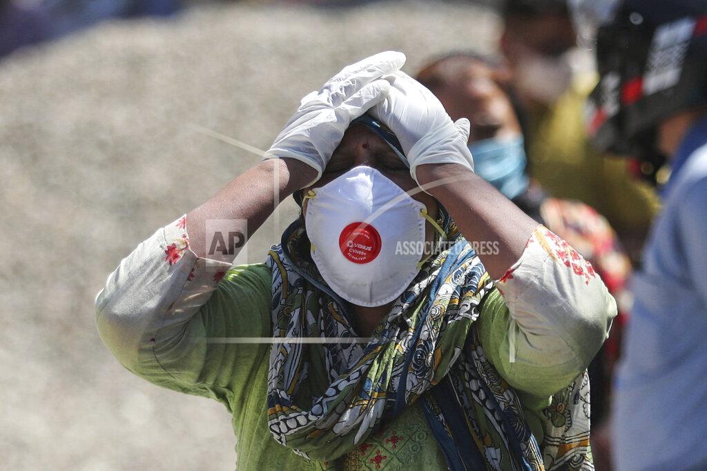 Channi Anand FILE - In this April. 25, 2021, file photo, a relative of a person who died of COVID-19 reacts at a crematorium in Jammu, India. Despite clear signs that India was being swamped by another surge of coronavirus infections, Prime Minister Narendra Modi refused to cancel campaign rallies, a major Hindu festival and cricket matches with spectators. The crisis has badly dented Modi’s carefully cultivated image as an able technocrat. (AP Photo/Channi Anand, File)