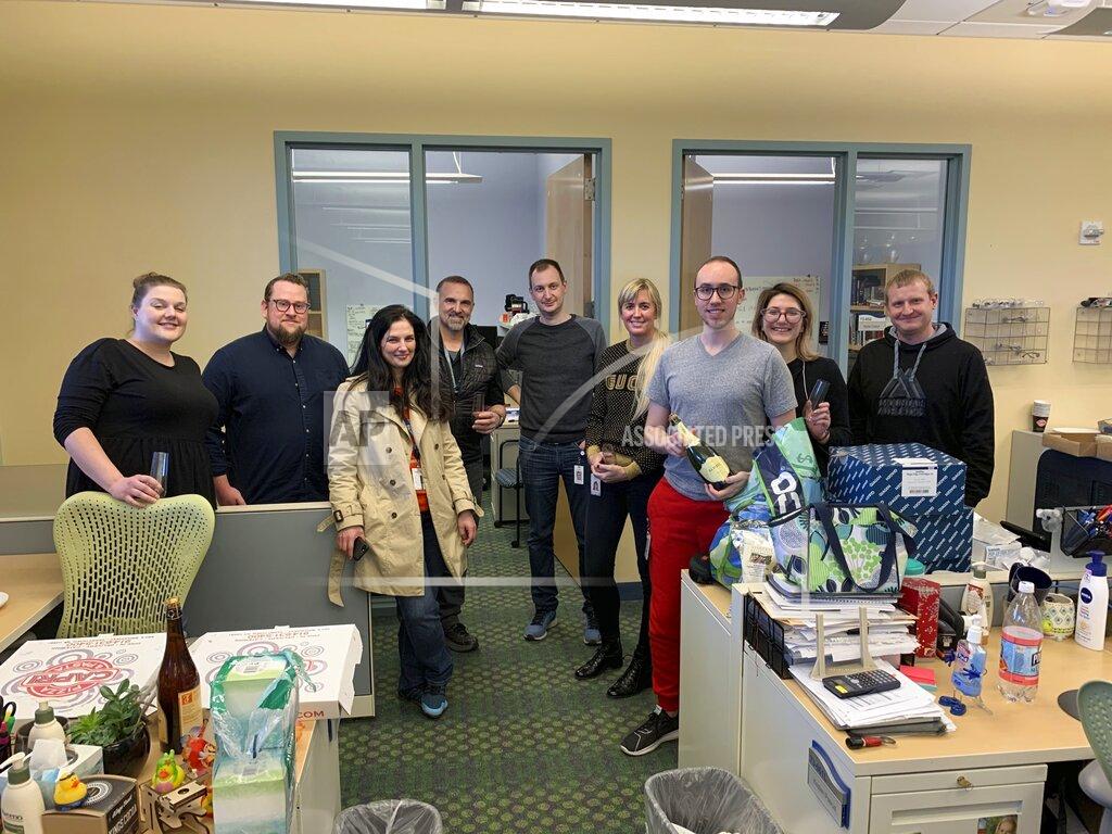 Uncredited In this Saturday, March, 14, 2020 photo provided by Regeneron, members of the company's infectious disease team pose for a photo as they celebrate their first discovery of potential antibodies to treat COVID-19. They had spent weeks drawing blood from early survivors across the globe and from mice with human-like immune systems - all to test thousands of potential treatments. (Regeneron via AP)