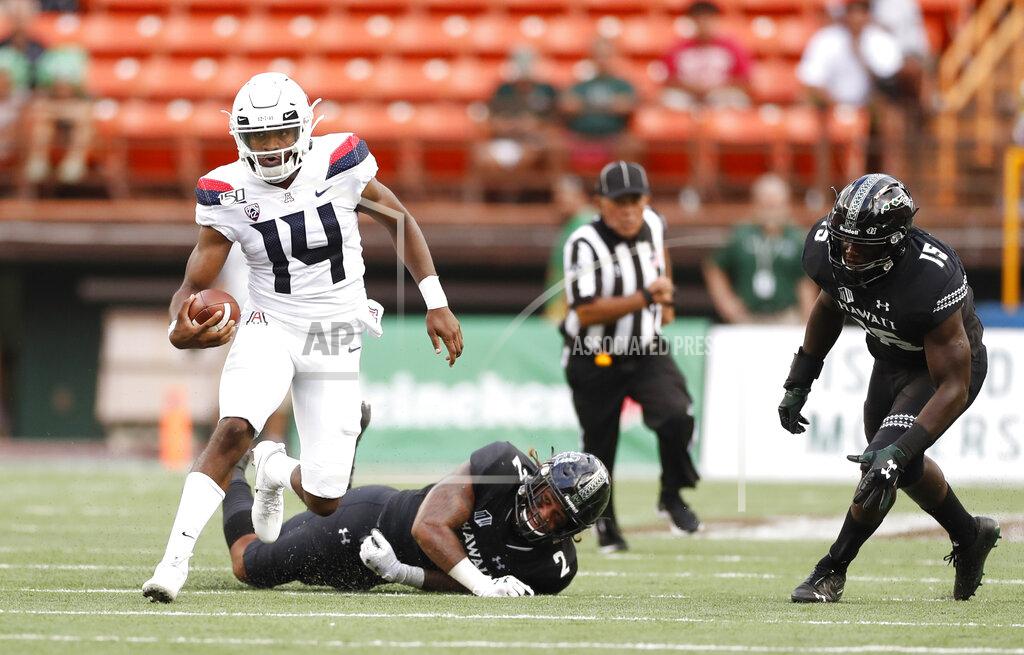 Marco Garcia Arizona quarterback Khalil Tate (14) runs through the Hawaii defense during the second quarter during an NCAA college football game, Saturday, Aug. 24, 2019, in Honolulu. (AP Photo/Marco Garcia)