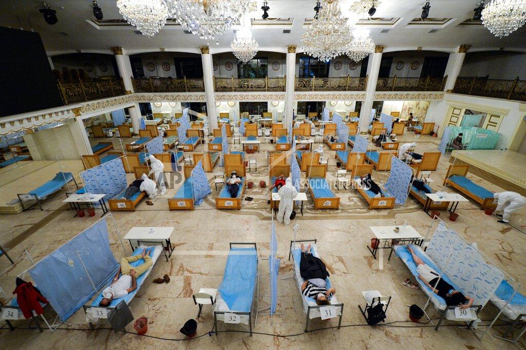 Vladimir Voronin A view of the hall of a restaurant that was converted into a clinic where medical workers help patients suspected of having the coronavirus in Bishkek, Kyrgyzstan, Wednesday, July 22, 2020. Consul, a restaurant in the center of Bishkek, was converted into a night-time clinic to support the country's health care system, struggling with the coronavirus outbreak. (AP Photo/Vladimir Voronin)