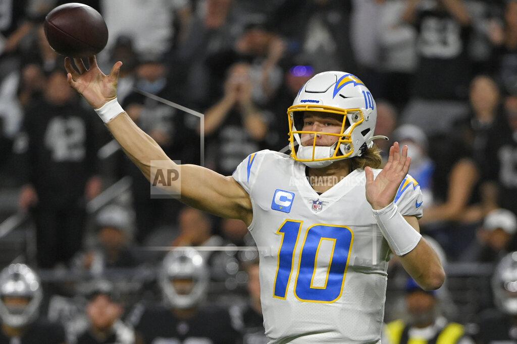 David Becker Los Angeles Chargers quarterback Justin Herbert (10) throws against the Las Vegas Raiders during the first half of an NFL football game, Sunday, Jan. 9, 2022, in Las Vegas. (AP Photo/David Becker)