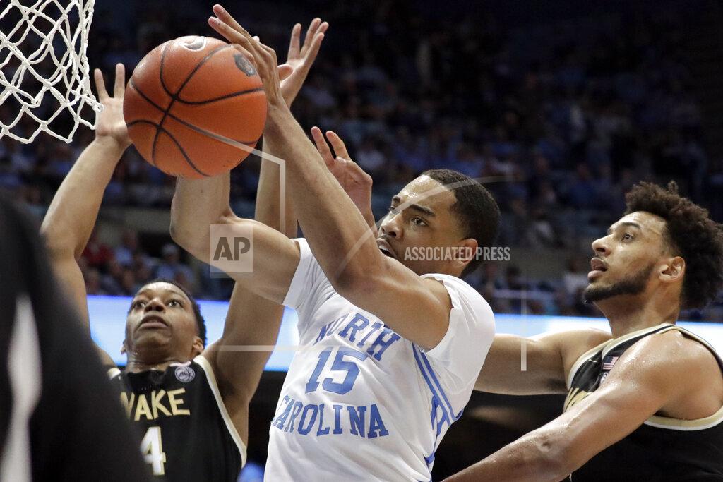 Chris Seward North Carolina's Garrison Brooks (15) pulls in a rebound against Wake Forest's Jahcobi Neath (4) and Olivier Sarr (30) during the second half of an NCAA college basketball game in Chapel Hill, N.C., Tuesday, March 3, 2020. (AP Photo/Chris Seward)