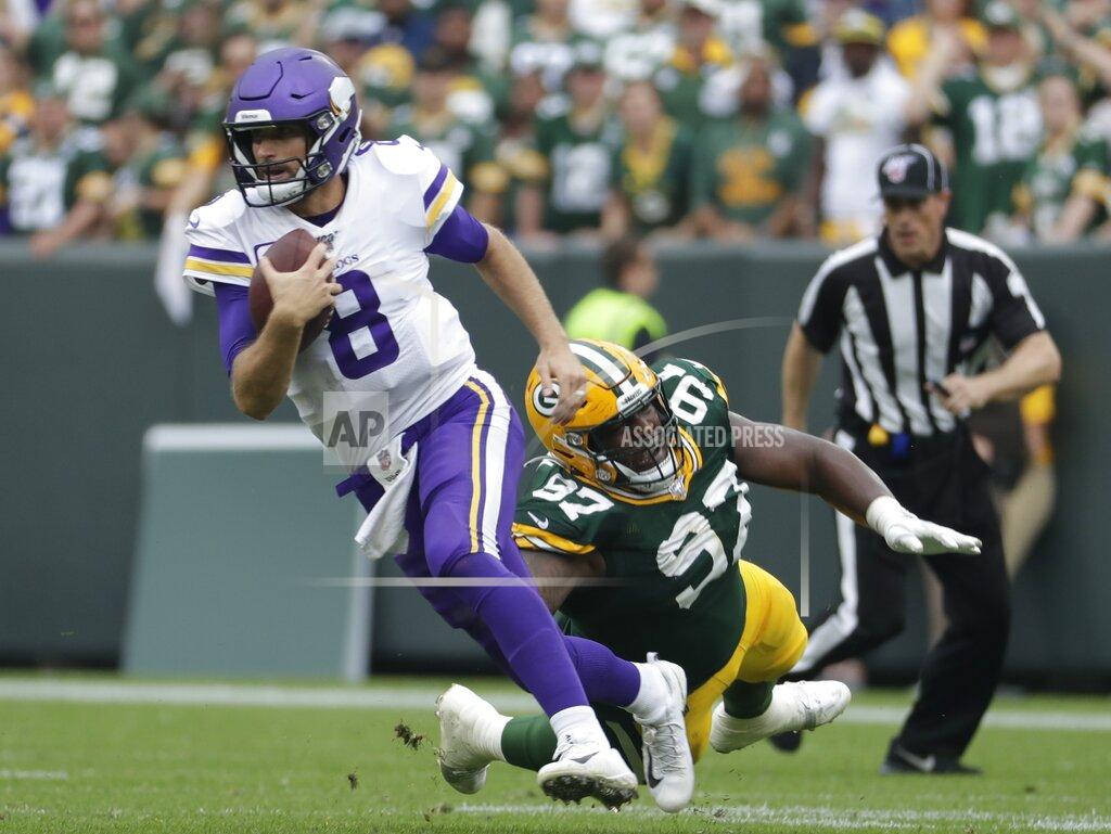 Morry Gash Minnesota Vikings' Kirk Cousins runs past Green Bay Packers' Kenny Clark during the second half of an NFL football game Sunday, Sept. 15, 2019, in Green Bay, Wis. (AP Photo/Morry Gash)