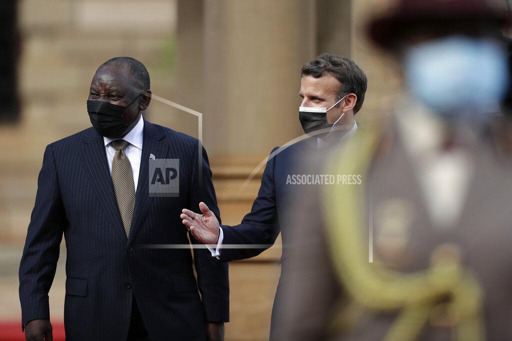 Themba Hadebe South African President Cyril Ramaphosa, left, and his French counterpart Emmanuel Macron talk during a welcoming ceremony at the government's Union Buildings, in Pretoria, South Africa, Friday, May 28, 2021. Macron is on a two-day official visit to the country. (AP Photo/Themba Hadebe, Pool)