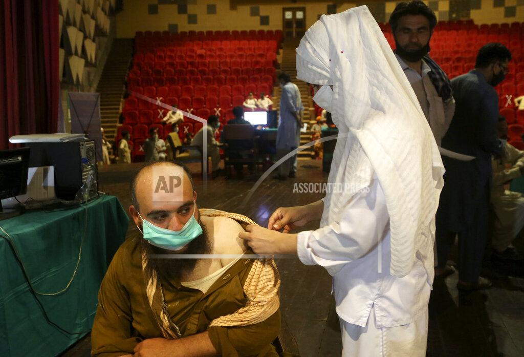 Muhammad Sajjad A government employee receives the Convidecia COVID-19 vaccine from a paramedic at a vaccination center in Nishtar hall, in Peshawar, Pakistan, Friday, June11, 2021. (AP Photo/Muhammad Sajjad)