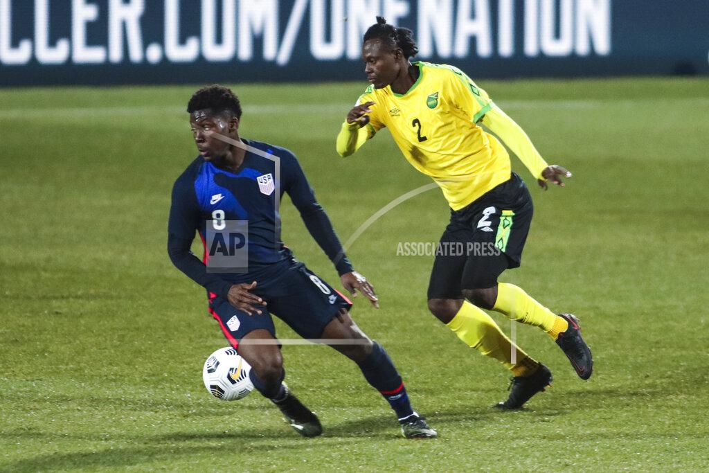 Ronald Zak USA's Yunus Musah, left, duels for the ball with Jamaica's Chavany Willis during the international friendly soccer match between USA and Jamaica at SC Wiener Neustadt stadium in Wiener Neustadt, Austria, Thursday, March 25, 2021. (AP Photo/Ronald Zak)