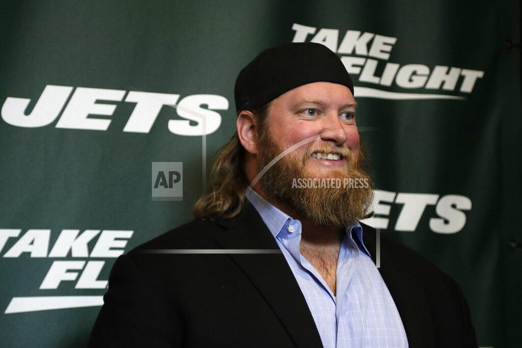 Julio Cortez FILE - Former New York Jets center Nick Mangold poses for photographers on the green carpet ahead of an event unveiling the team's new NFL football uniforms, Thursday, April 4, 2019, in New York. The Jets will induct former cornerback Darrelle Revis, center Nick Mangold and left tackle D'Brickashaw Ferguson into the team's Ring of Honor during separate halftime ceremonies this season. The team announced Thursday, June 2, 2022, that Mangold will be the first honored with a ceremony during the Jets' game against Cincinnati on Sept. 25. Ferguson's induction will be Oct. 30 against New England, and Revis' will be Nov. 27 against Chicago.(AP Photo/Julio Cortez, File)