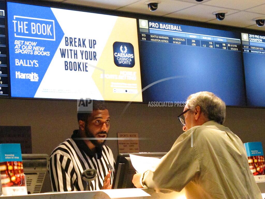 Wayne Parry FILE - A gambler makes a sports bet at Bally's casino in Atlantic City N.J., Sept. 5, 2019. A record 31.5 million Americans plan to bet on this year's Super Bowl, according to the gambling industry's national trade group. The American Gaming Association on Tuesday, Feb. 8, 2022, released its annual predictions for wagering on pro football's championship game, forecasting that over $7.6 billion will be bet legally and otherwise. (AP Photo/Wayne Parry, File)