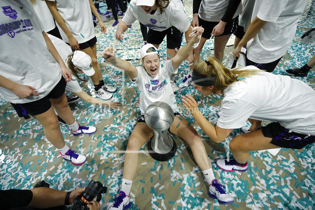 John Locher FILE - In this Tuesday, March 10, 2020, file photo, Portland's Keeley Frawley, center, celebrates with teammates after defeating San Diego in an NCAA college basketball game in the final of the West Coast Conference women's tournament in Las Vegas. The WCC Presidents' Council will delay the beginning of fall competition in all Conference sports due to the COVID-19 pandemic. WCC programs will not participate in any competition prior to Sept. 24, 2020. This decision includes the traditional fall seasons in men's and women's cross country, men's and women's soccer and women's volleyball. Baseball, beach volleyball, men's and women's golf, women's rowing, softball and men's and women's tennis, which hold their traditional seasons in the spring, will not participate in a fall competition scheduled prior to Sept. 24. (AP Photo/John Locher, File)