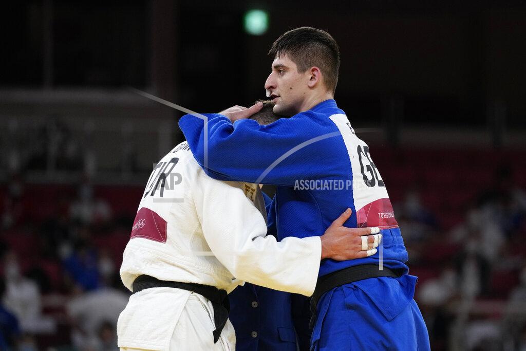 Vincent Thian Eduard Trippel of Germany, right comforts Michael Zgank of Turkey after winning their men -90kg semifinal round against unseen, in the judo match at the 2020 Summer Olympics in Tokyo, Japan, Wednesday, July 28, 2021. (AP Photo/Vincent Thian)