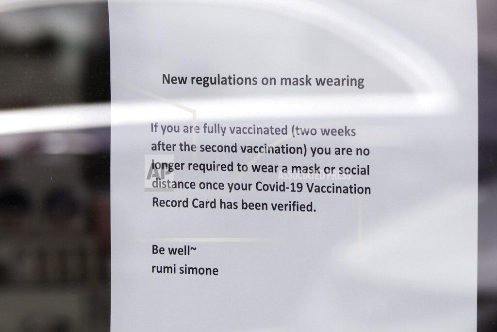 Gillian Flaccus A sign at a spa and beauty salon in Lake Oswego, Oregon on Friday, May 21, 2021, advises that only customers who can prove they are fully vaccinated may enter without masks on. As the federal government and many states ease rules around mask-wearing and business occupancy, some blue states like Oregon and Washington are still holding on to some longtime coronavirus restrictions. (AP Photo/Gillian Flaccus)