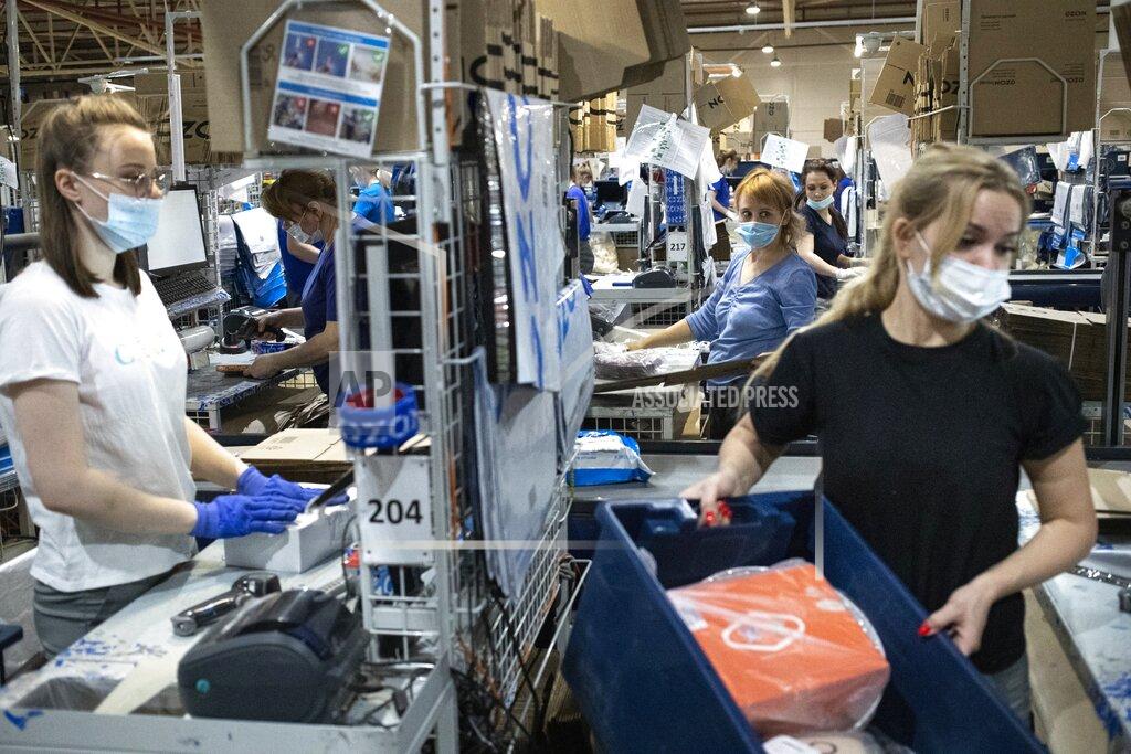 Pavel Golovkin Employees work at Ozon, a major Russian e-commerce platform similar to Amazon, in Moscow, Russia, Thursday, March 25, 2021. Ozon saw its sales jump almost 2.5 times last year, the company’s communications director Maria Zaikina said. (AP Photo/Pavel Golovkin)