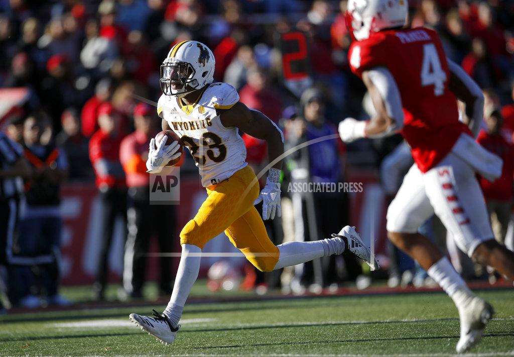 Andres Leighton Wyoming running back Xazavian Valladay (23) sprints to the end zone to score a touchdown past New Mexico safety Bijon Parker (4) during the second half of an NCAA college football game in Albuquerque, N.M., Saturday, Nov. 24, 2018. Wyoming won 31-3. (AP Photo/Andres Leighton)