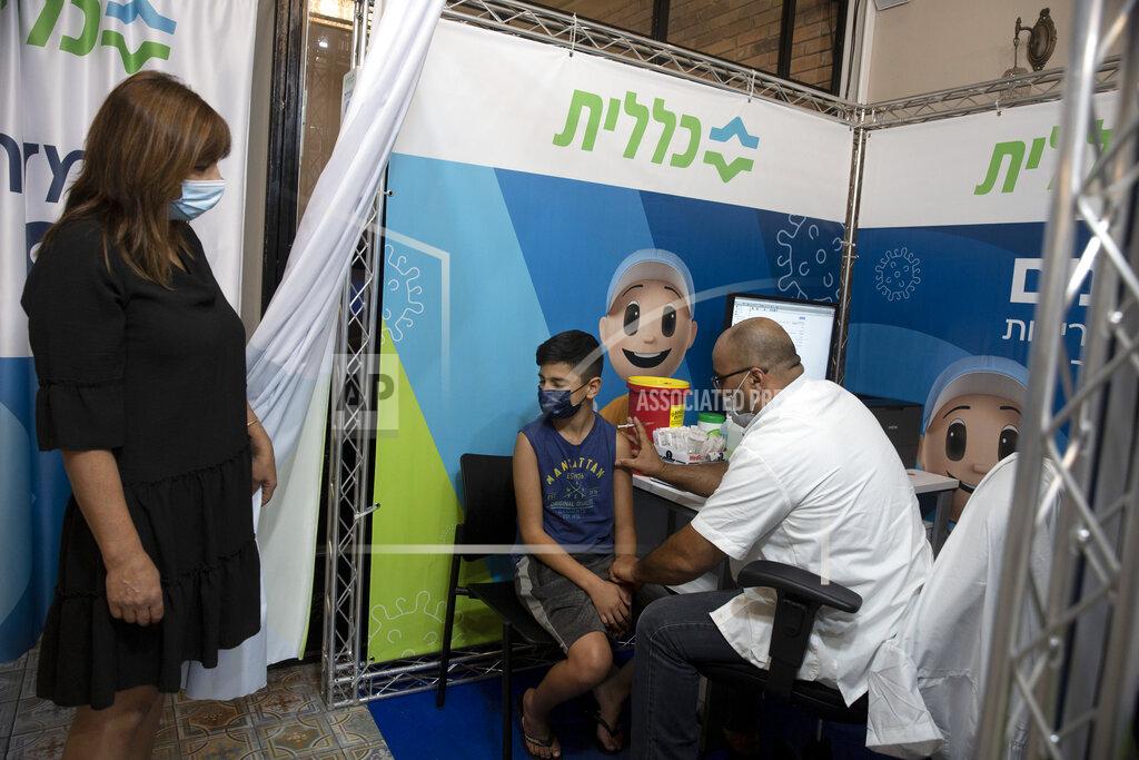 Maya Alleruzzo FILE - In this Aug. 15, 2021, file, photo, a 12-year-old boy braces himself as a medical professional prepares to administer the coronavirus vaccine at Clalit Health Services, one of Israel's health maintenance organizations, in Jerusalem. Israel is pressing ahead with its aggressive campaign of offering coronavirus boosters to almost anyone over 12 and says its approach was further vindicated by a U.S. decision to give the shots to older patients or those at higher risk. (AP Photo/Maya Alleruzzo, File)
