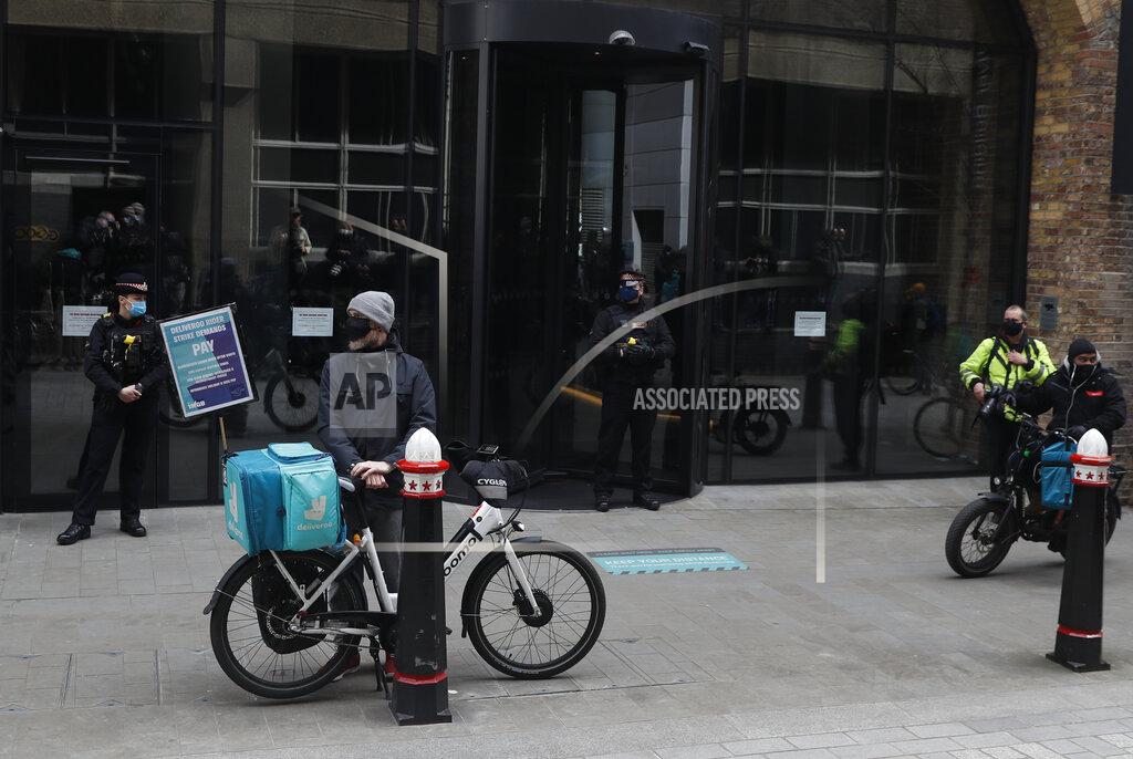 Alastair Grant Gig economy riders for app-based meal delivery platform Deliveroo demonstrate outside the company headquarters in London, Wednesday, April 7, 2021. The strike coincides with the first day of unconditional trading for Deliveroo shares, which went public last week in a stock market offering.(AP Photo/Alastair Grant)