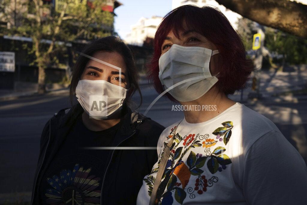 Burhan Ozbilici Women wearing masks to help protect against the spread of coronavirus, speak as they walk during a lockdown, in Ankara, Turkey, Tuesday, May 11, 2021. Turkey's daily COVID-19 infections have dropped to levels last seen in mid-March as the country nears two weeks in its strictest restrictions. Heath Ministry statistics showed 14,497 new infections Tuesday and 278 deaths.(AP Photo/Burhan Ozbilici)