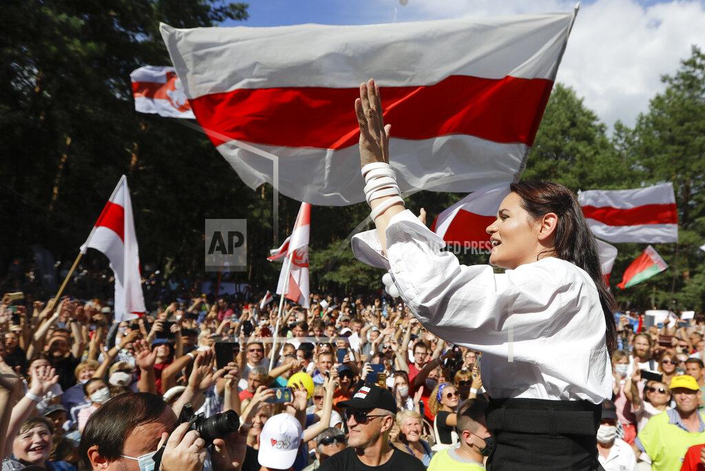 Sergei Grits FILE In this file photo taken on Sunday, Aug. 2, 2020, Sviatlana Tsikhanouskaya, candidate for the presidential elections greets people waving old Belarus flags during a meeting to show her support , in Brest, 326 km (203,7 miles) southwest of Minsk, Belarus. Tsikhanouskaya, 37-year old former English teacher without any political experience seems an unlikely challenger to the authoritarian leader of Belarus, whose rule has spanned more than quarter-century. (AP Photo/Sergei Grits, FILE)