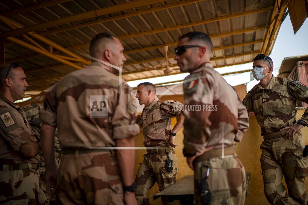 Uncredited French Barkhane force soldiers who wrapped up a four-month tour of duty in the Sahel leave their base in Gao, Mali Wednesday June 9, 2021. After France suspended joint military operations with Malian forces after the junta led by Col. Assimi Goita retook control of Mali's transitional government May 24 2021, French President Emmanuel Macron announced at a press conference Thursday June 10, 2021 That operation Barkhane would end and be replaced by support for local partners and counter terrorism. (AP Photo/Jerome Delay)