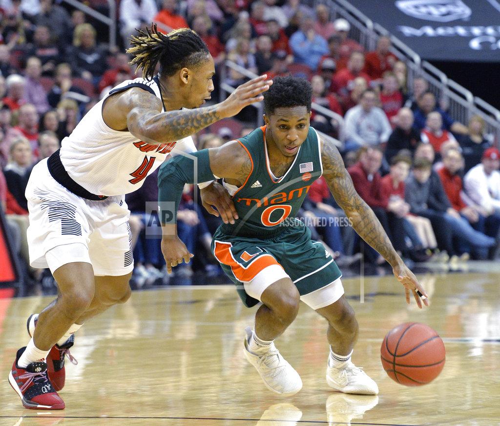 Timothy D. Easley Miami guard Chris Lykes (0) attempts to drive past the defense of Louisville guard Khwan Fore (4) during the first half of an NCAA college basketball game in Louisville, Ky., Sunday, Jan. 6, 2019. (AP Photo/Timothy D. Easley)