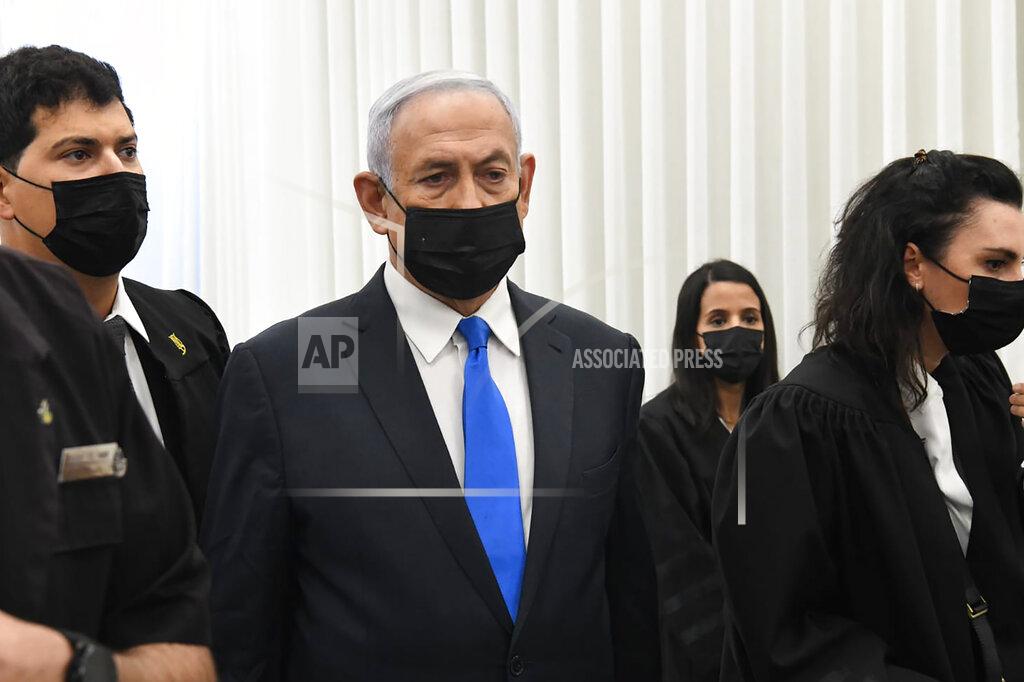 Reuven Castro Israeli Prime Minister Benjamin Netanyahu stands at a hearing at the district court in Jerusalem, Monday, Feb. 8, 2021. Netanyahu appeared in a Jerusalem courtroom Monday to respond formally to corruption charges just weeks before national elections in which he hopes to extend his 12-year rule. (AP Photo/Reuven Castro, Pool)
