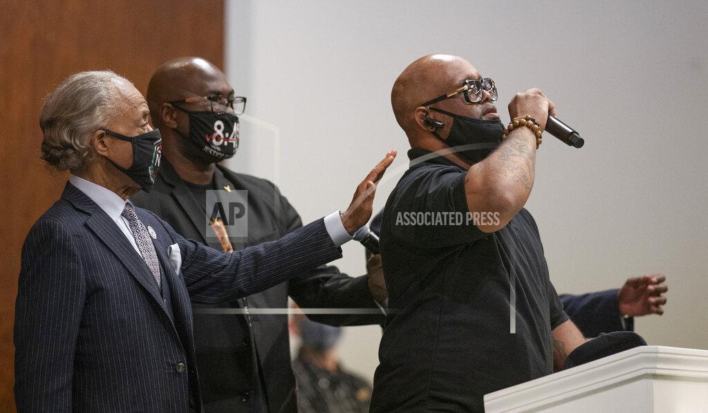 Jerry Holt Terrence Floyd, right, brother of George Floyd, speaks during a prayer service at Greater Friendship Missionary Church as The Rev. Al Sharpton, left, and his brother Philonise Floyd place their hands on his back, Sunday, March 28, 2021, in Minneapolis. Opening statements are set for Monday in the trial of a former Minneapolis police officer charged with murder and manslaughter in George Floyd's death. (Jerry Holt/Star Tribune via AP)